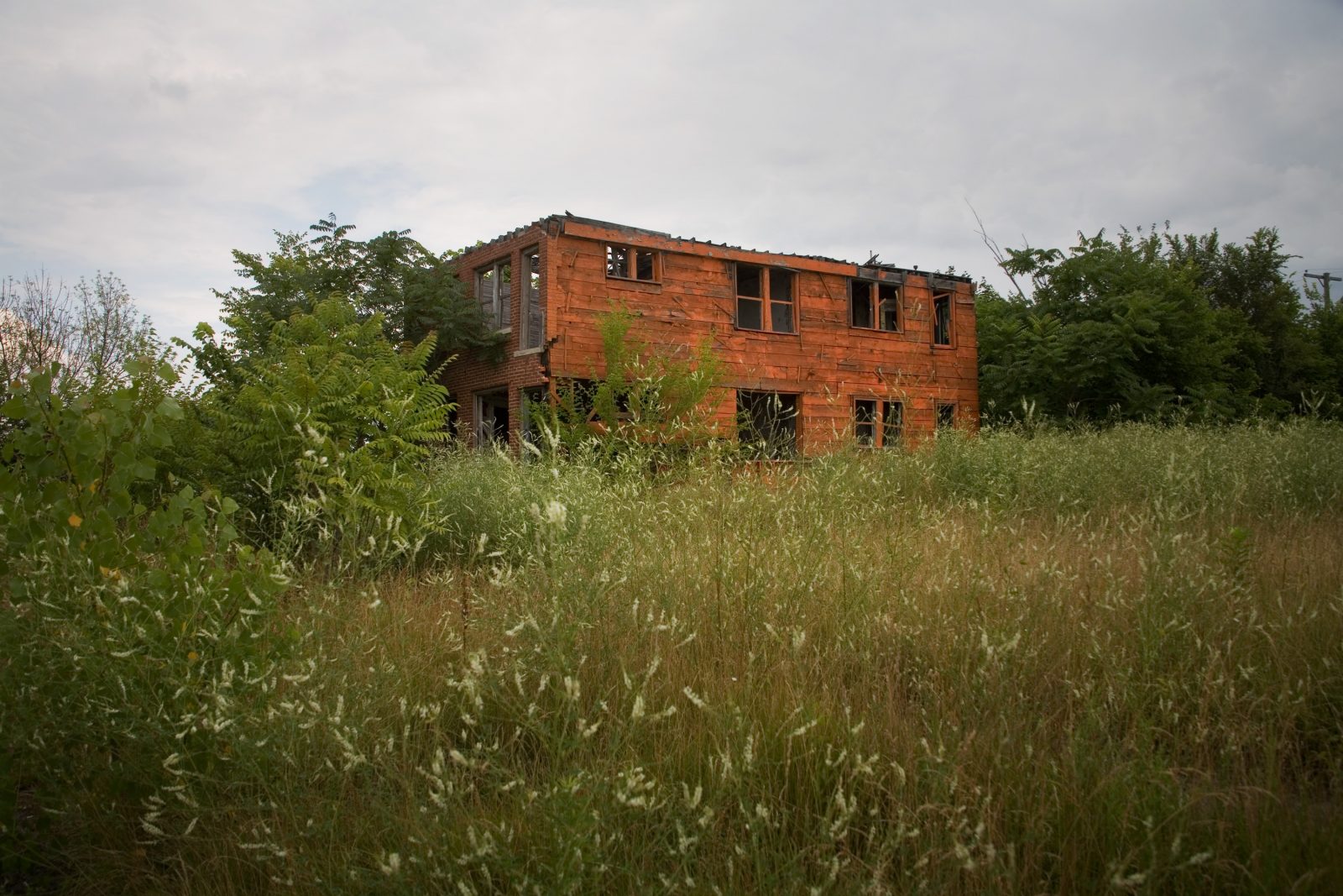 Orange house in an abandoned neighborhood in Detroit.